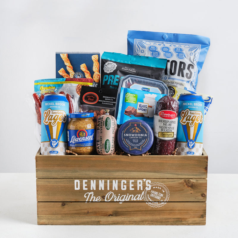 The meat and beer crate gift basket includes a variety of meats (mini salami sticks, pate, salami), salty snacks, popcorn, cheese, sweets and two Nickel Brook beers. All wrapped up in a wooden crate.