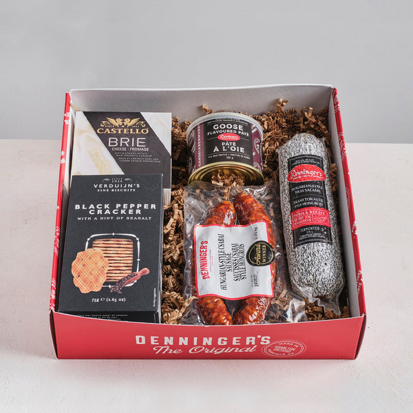 The Mini Charcuterie Box includes a Castello Brie, Denninger's German Salami, Snowdonia Chutney, Verduijns' black pepper crackers, and Denninger's Goose pate. All packed up in a lovely window box.