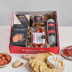 The Mini Charcuterie Box includes a Castello Brie, Denninger's German Salami, Snowdonia Chutney, Verduijns' black pepper crackers, and Denninger's Goose pate. All packed up in a lovely window box.