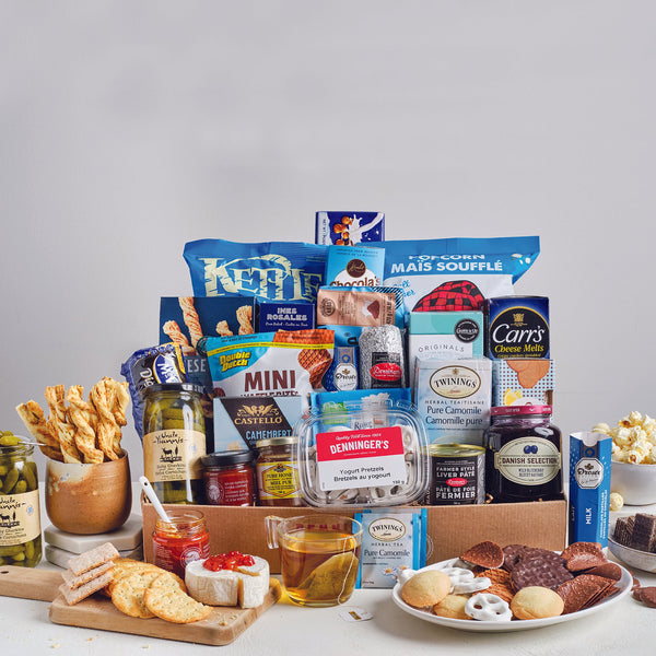 Our large basket is a selection of sweet and salty snacks, salami, brie, pickles, mustard, tea, and more. 