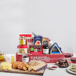 Our Wine and Cheese Gift Basket includes four luxurious cheeses, an array of crackers, and delectable honey and chocolate, perfectly paired with local 13th Street Wine.