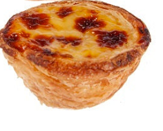 One Portuguese tart with a creamy custard center blistered on top with a   crispy, flaky crust.