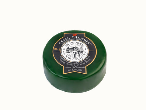 Encased in green wax 200 grams of  Snowdonia cheddar cheese with garlic and herbs.