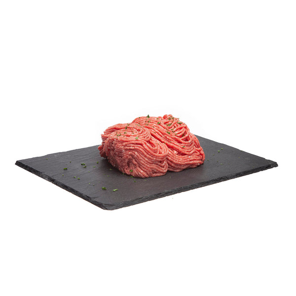 454 grams of uncooked Canadian lean ground beef - displayed on a black slate board.