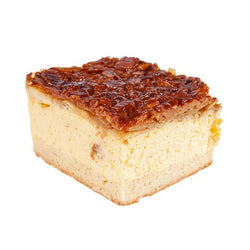  German style cake slice is comprised of two thin layers of yeast cake with a vanilla cream filling, topped with a crunchy honey almond topping