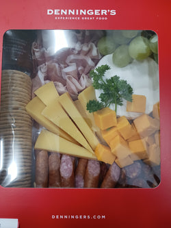 Charcutiere box with cheddar, brie, gouda, Hungarian-style csabai, kabanossi, Recla Speck, Snowdonia Chutney, Carr's Crackers and grapes for garnish.