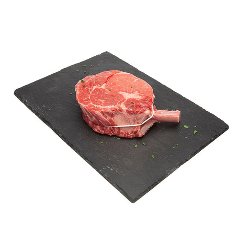 1 kg  Raw AAA Canadian Beef: Prime Rib Roast displayed on a black slate board.