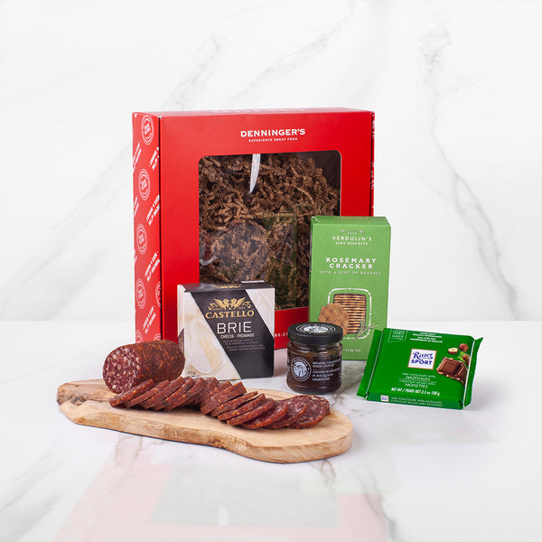 The mini charcuterie gift box includes a salami, brie cheese, crackers, chocolate and chutney.